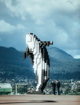 The striking Digital Orca sculpture set against Vancouver's stunning landscape.