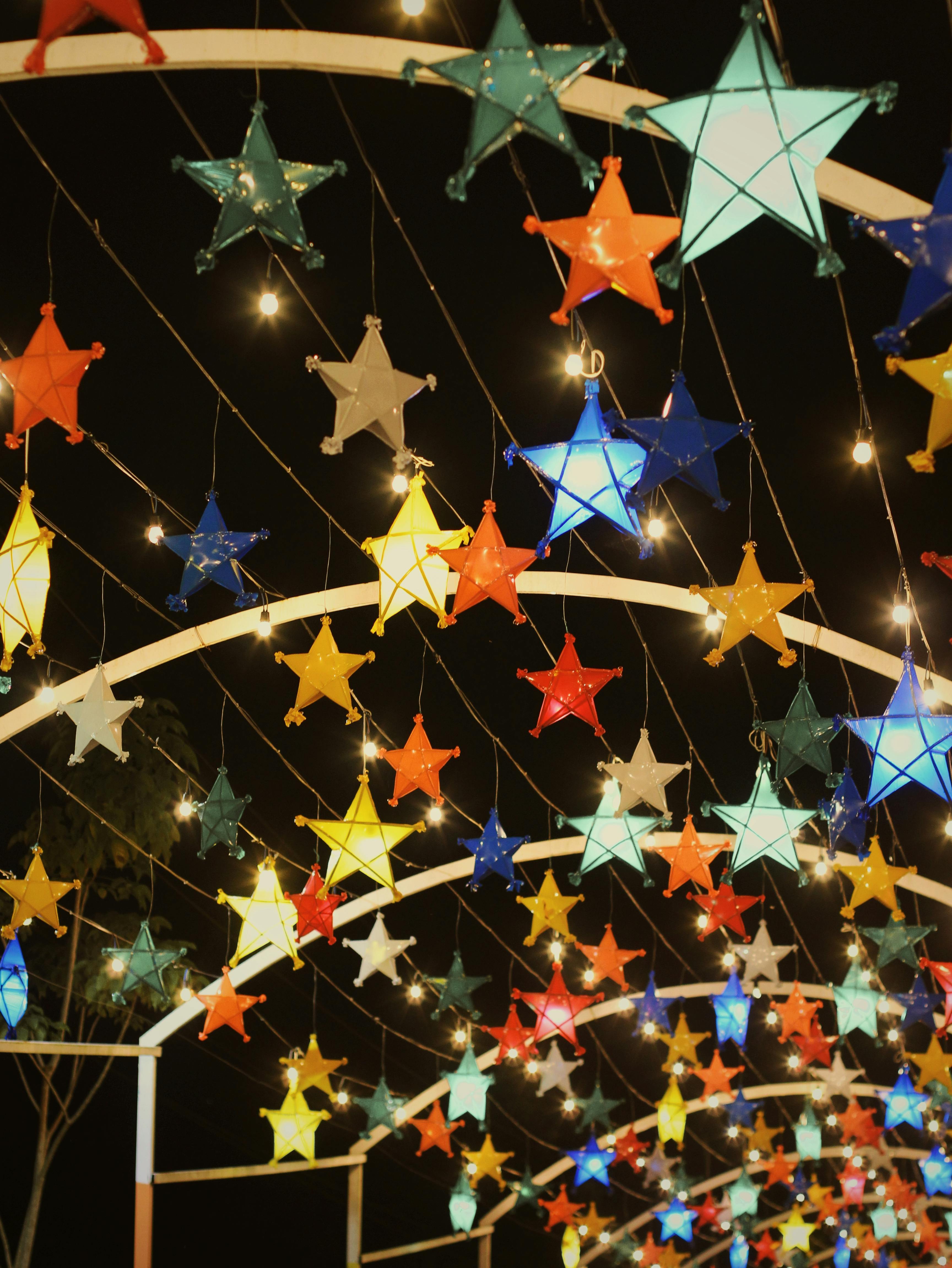 Bright and colorful star-shaped lanterns light up the night with festive charm.