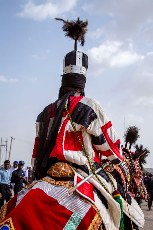 Free A man in traditional attire rides a horse during a cultural ceremony in Zaria. Stock Photo