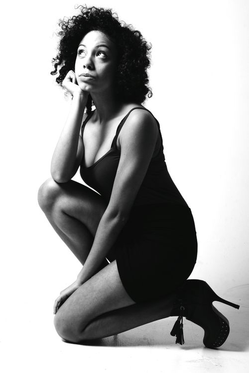 Free Stylish black and white portrait of a kneeling woman in a dress and high heels. Stock Photo
