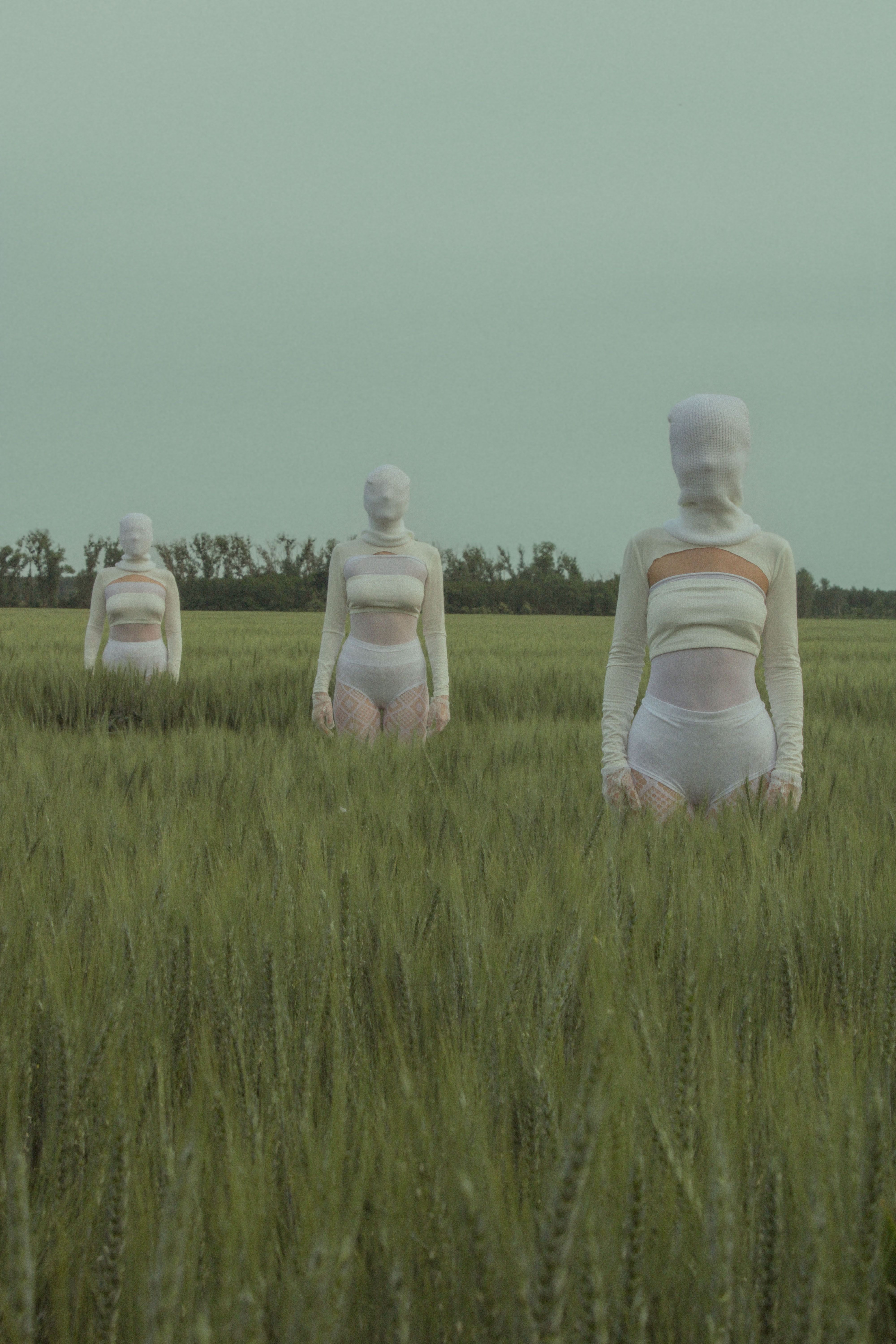 Three women in white outfits standing in a field · Free Stock Photo