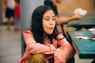 A Girl Sitting at the Table