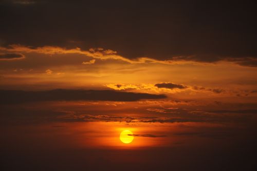 Free Beautiful sunset with vibrant orange sky and dramatic clouds over Mumbai, India. Stock Photo