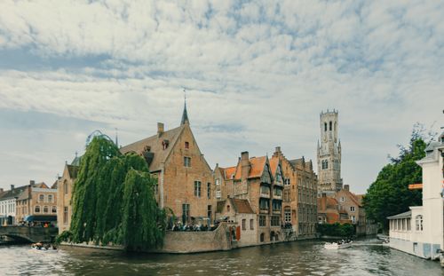 Free Historic buildings and canal with the Belfry of Bruges in view. Stock Photo