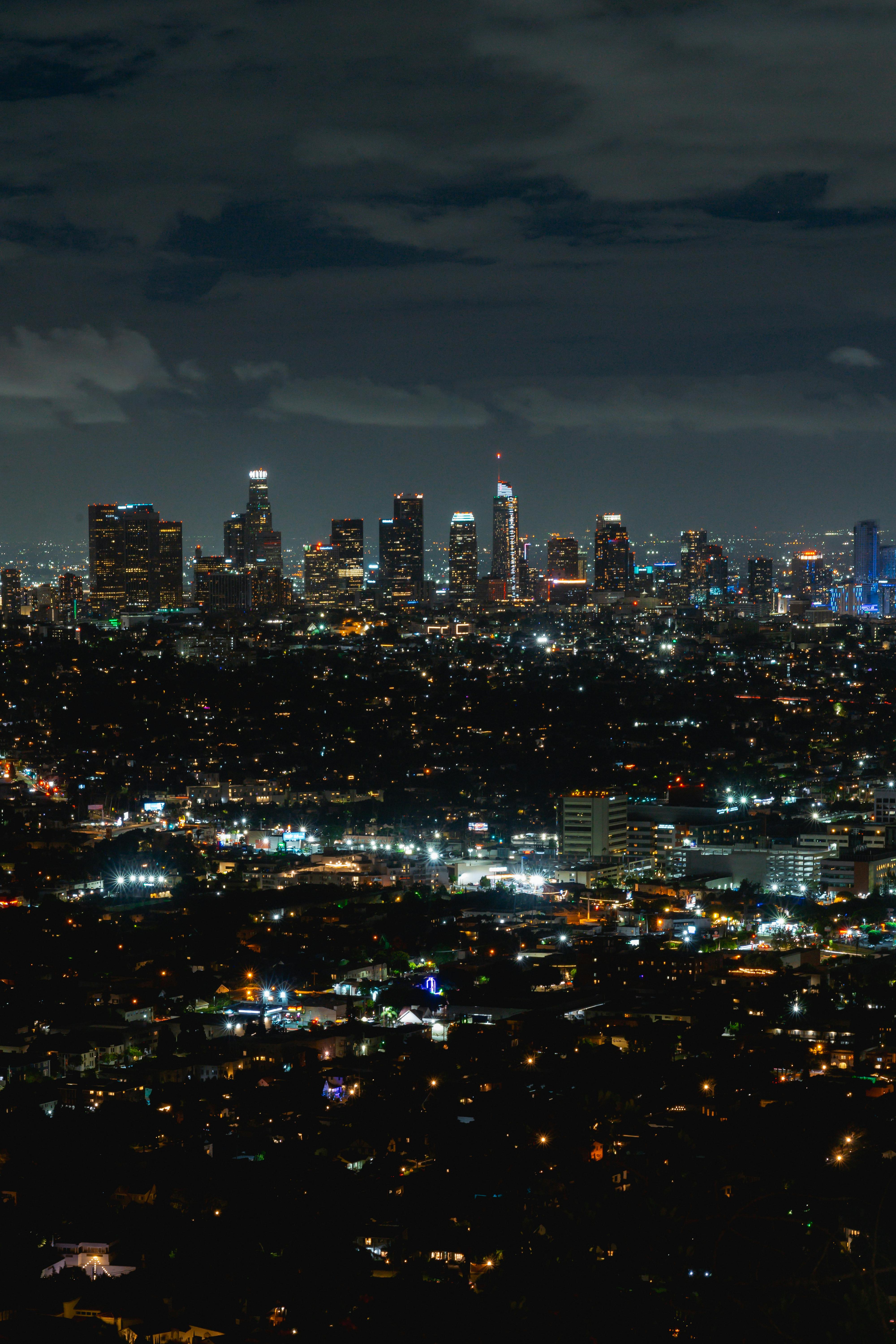 aerial view of illuminated skyscrapers in a city at night