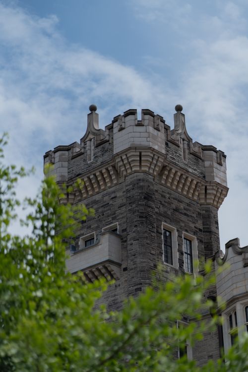 Free A detailed view of Casa Loma's neo-gothic architecture with green foliage. Stock Photo