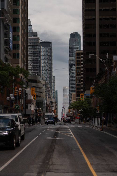 Free A vibrant city street scene showcasing the towering skyscrapers and bustling urban life of a downtown district. Stock Photo