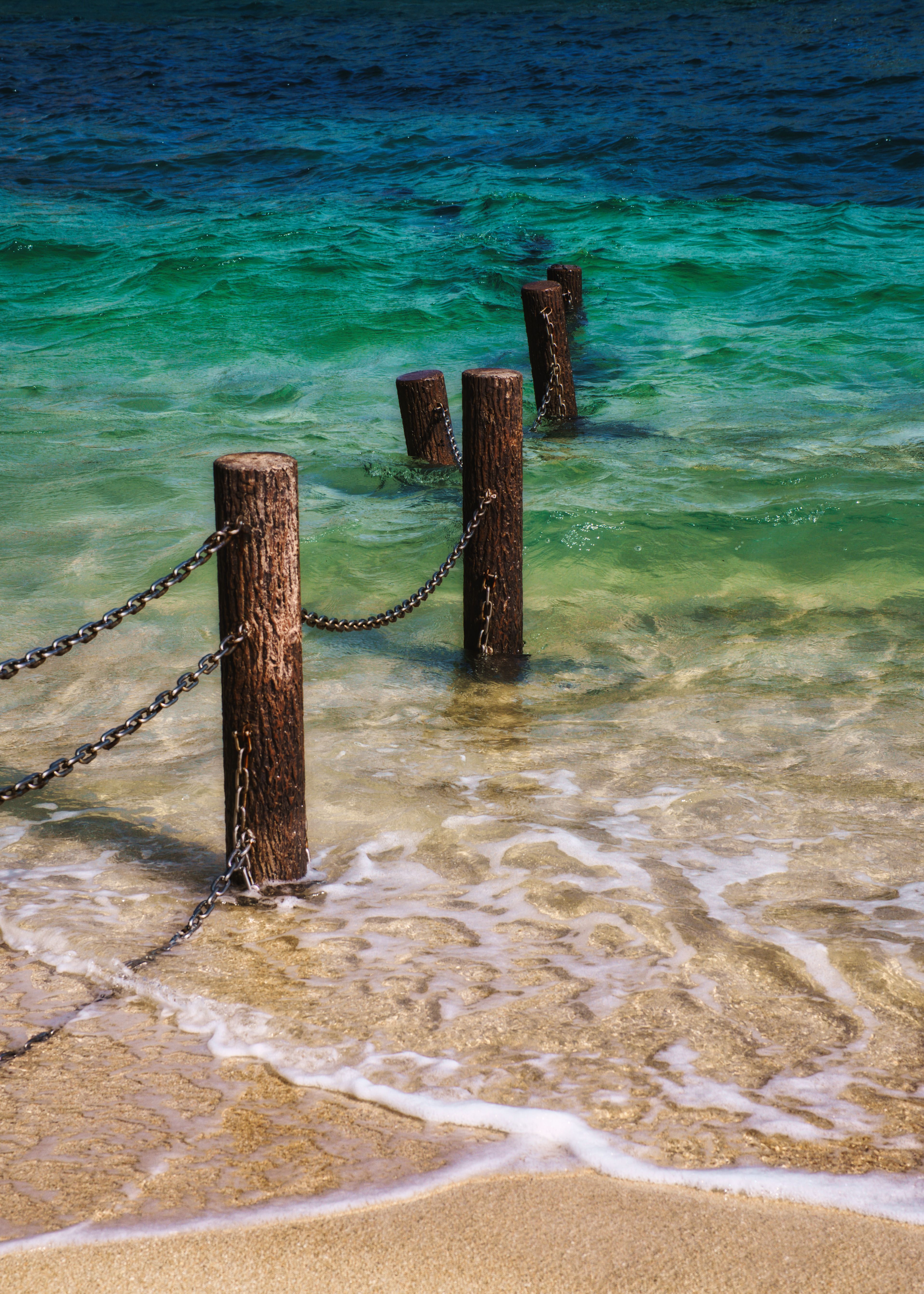 Wooden Posts with Chains on Sea Shore · Free Stock Photo