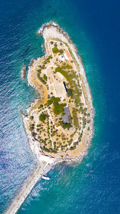 Free Stunning aerial view of Güvercinada Island in Kuşadası, surrounded by blue waters. Stock Photo