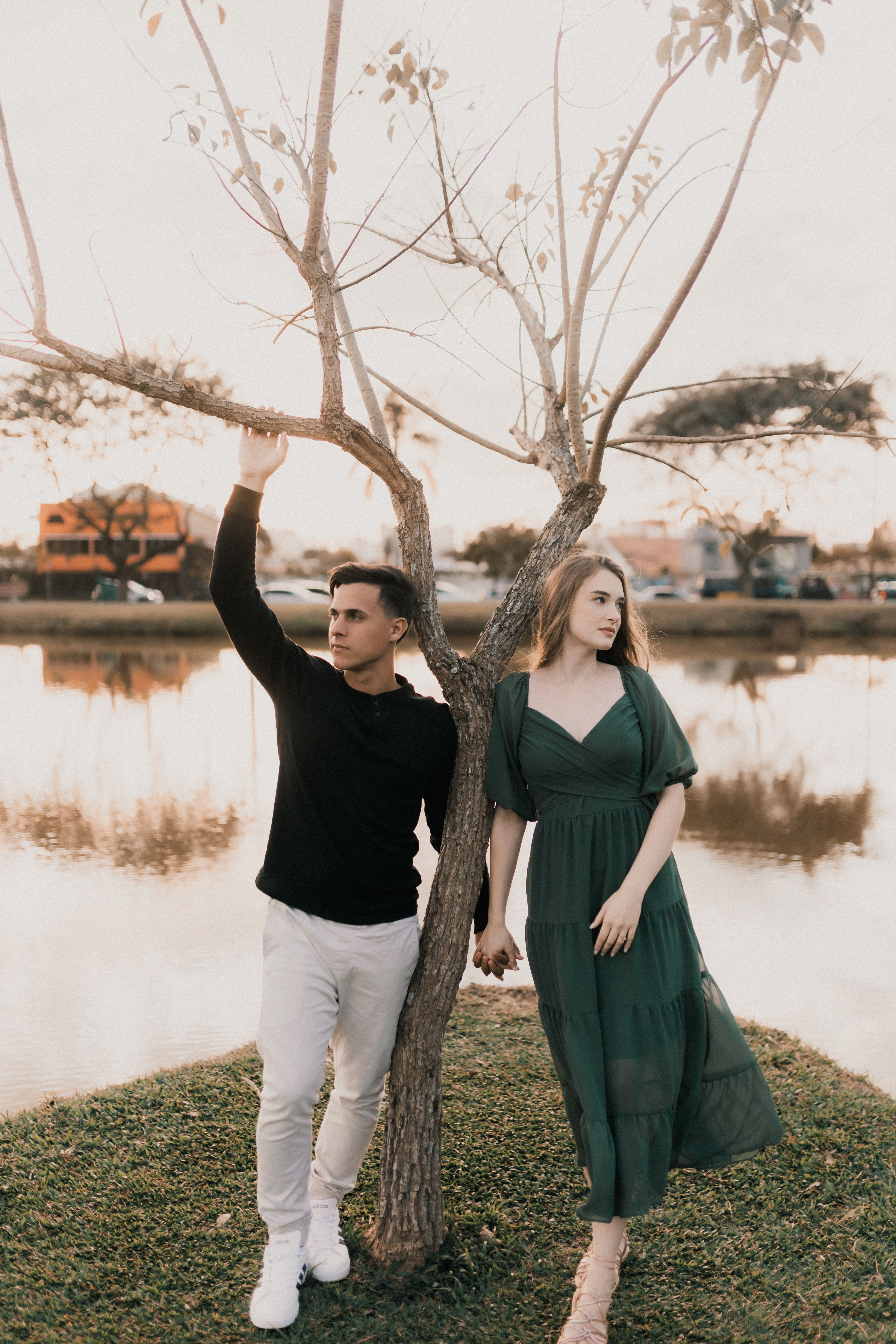 A Man and Woman Standing in the Park by the Body of Water · Free Stock ...