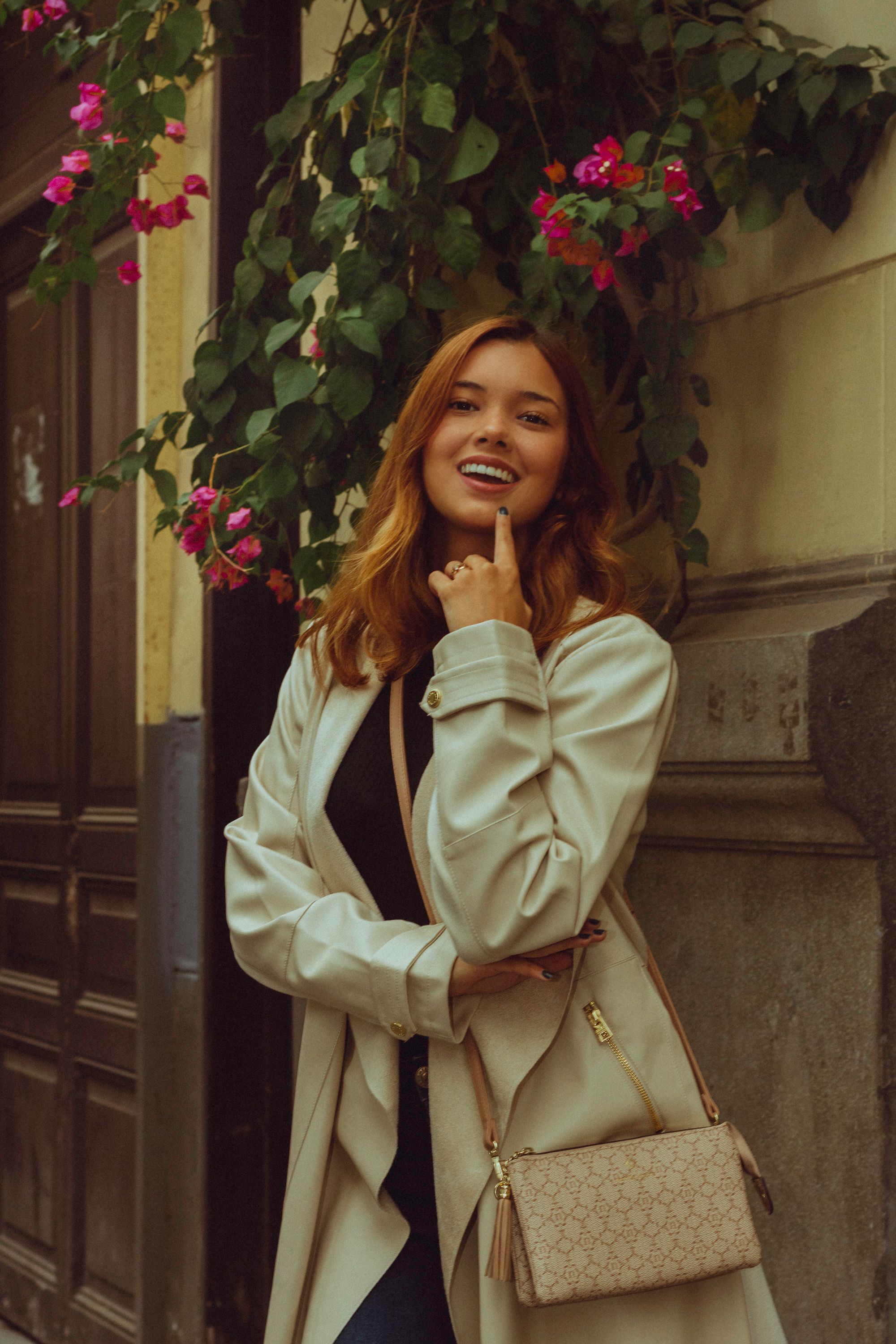 Portrait of a stylish woman smiling in Lima's vibrant cityscape.