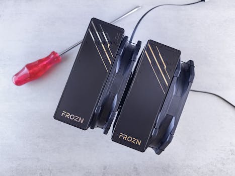 Top view of a FROZN CPU cooler with a screwdriver on a white background, showcasing advanced cooling technology.