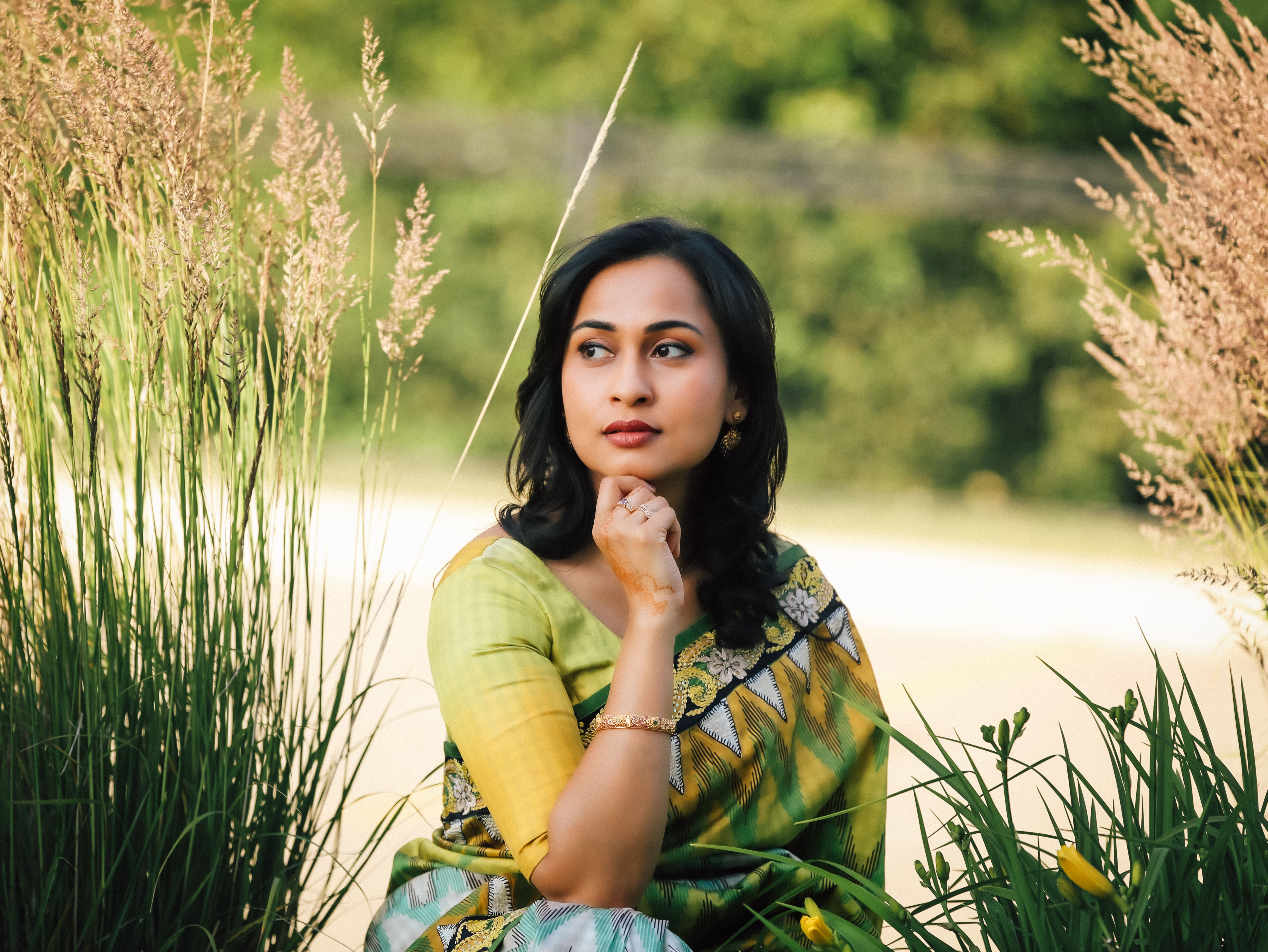 Portrait of a Pretty Brunette Sitting between Reeds · Free Stock Photo