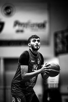 A focused basketball player preparing to shoot, captured in black and white