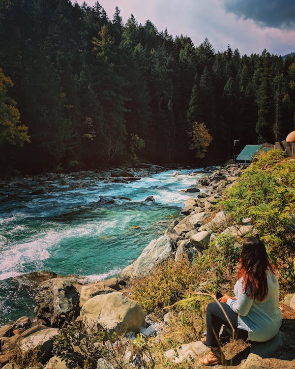 Free Woman Sitting Beside the River Stock Photo