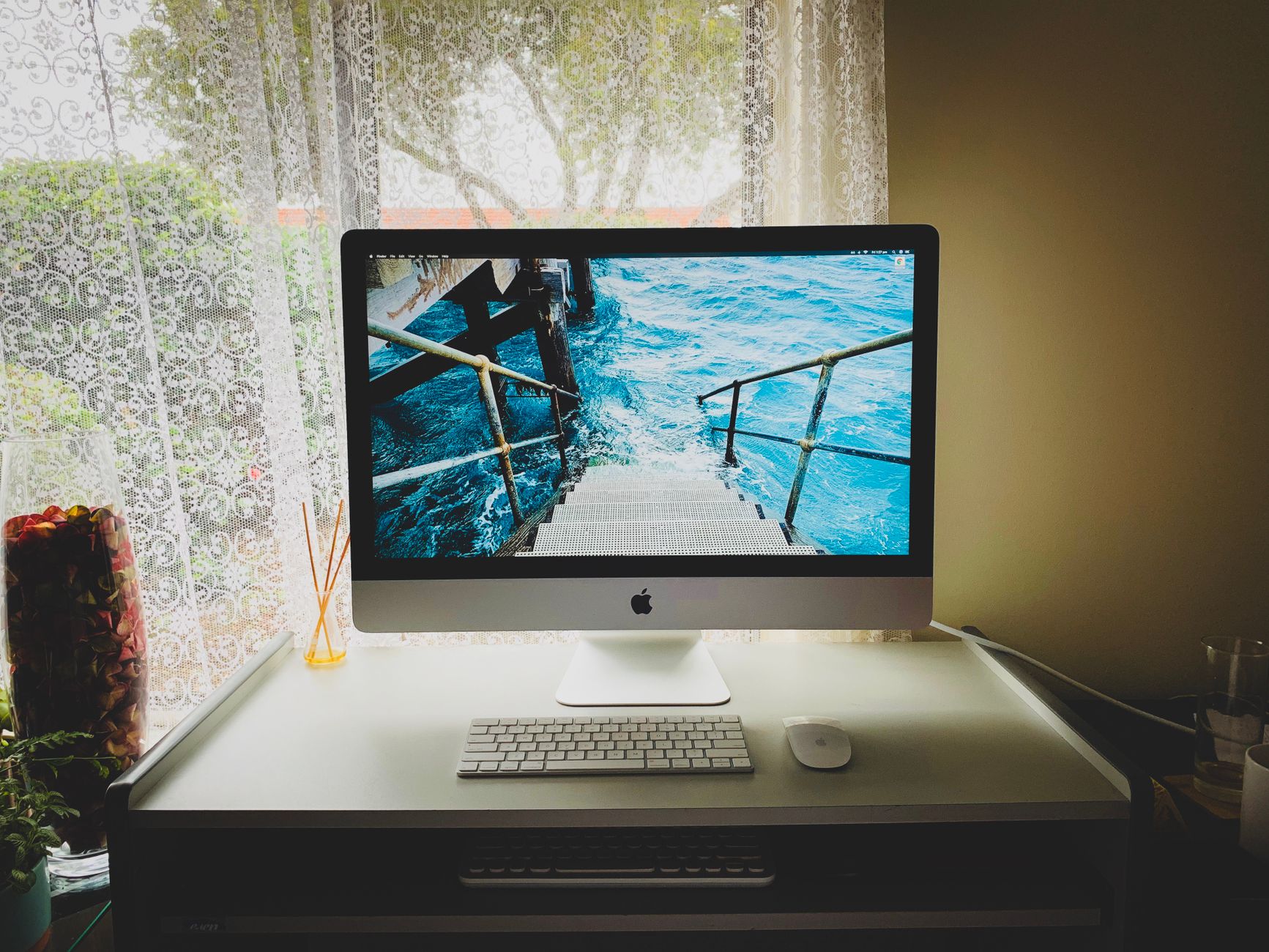 Sleek and modern computer setup on a desk by a window, showcasing productivity.. sleek, modern, computer
