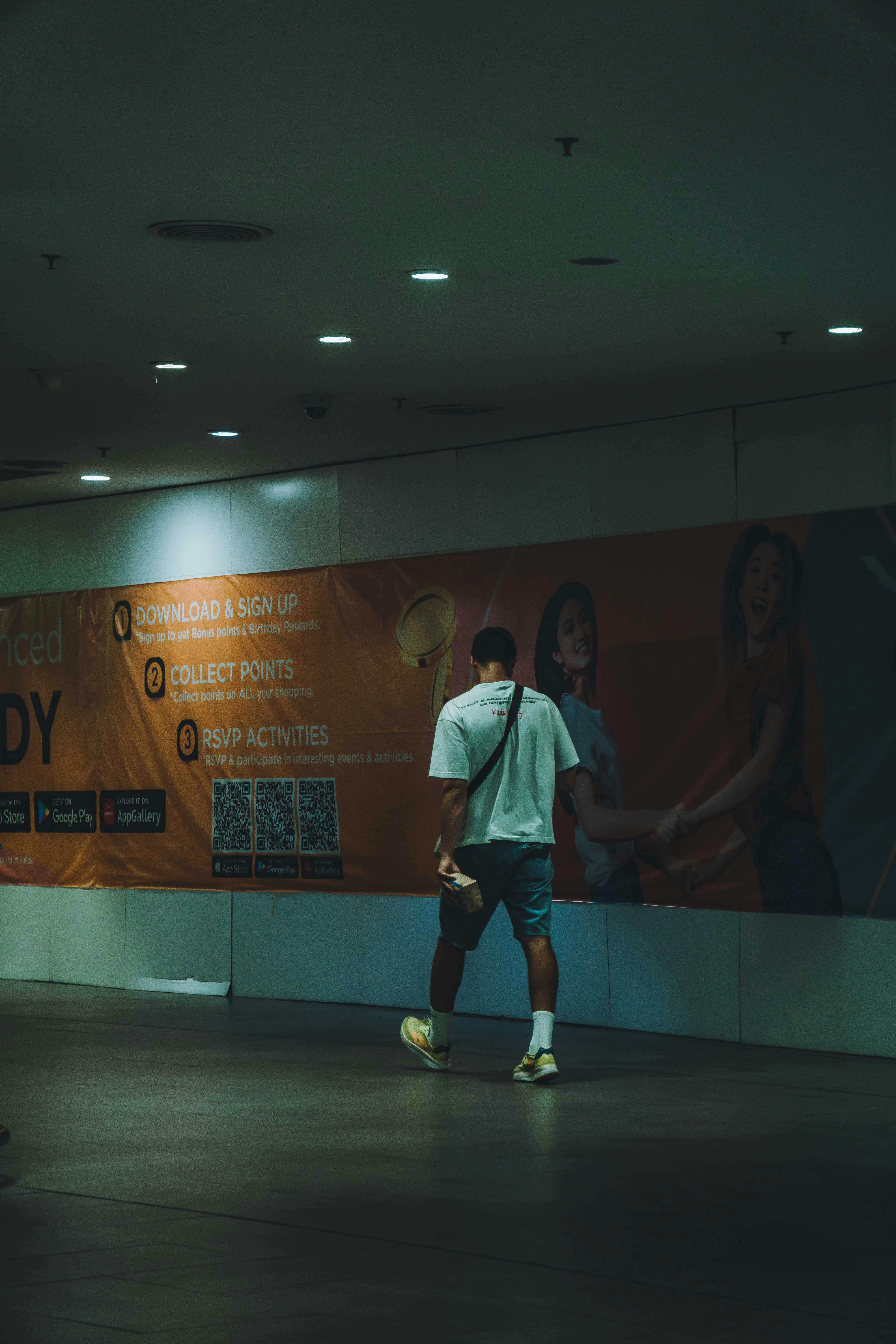 a man walking in an empty hallway