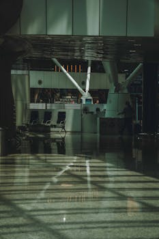 Artistic capture of Kuala Lumpur Airport's sleek and modern interior design featuring intriguing reflections and shadows.