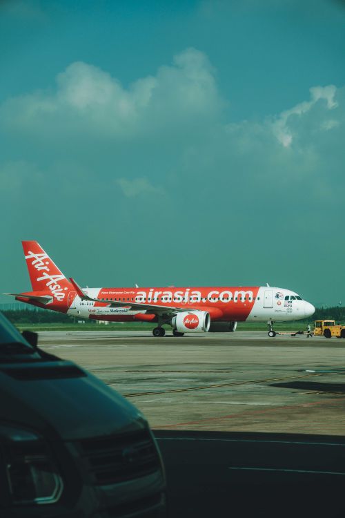 Free AirAsia airplane on the runway at Ho Chi Minh City airport, ready for takeoff. Stock Photo