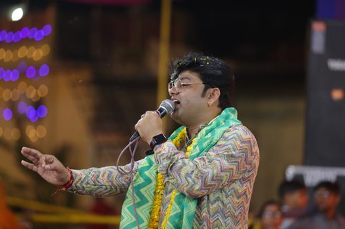 Free A vibrant performance by a male singer at an outdoor event in Jaipur, India. Stock Photo