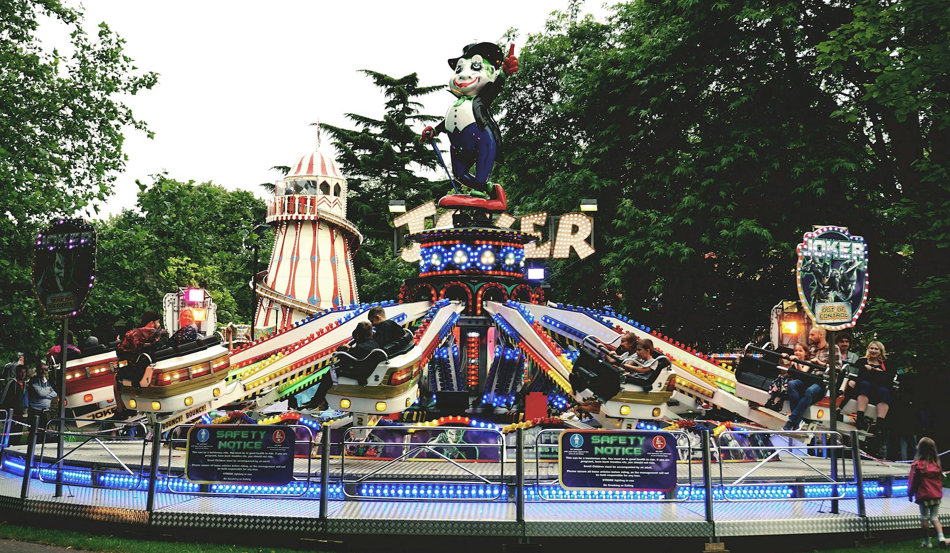 Colorful amusement park ride with people enjoying the fairground atmosphere.