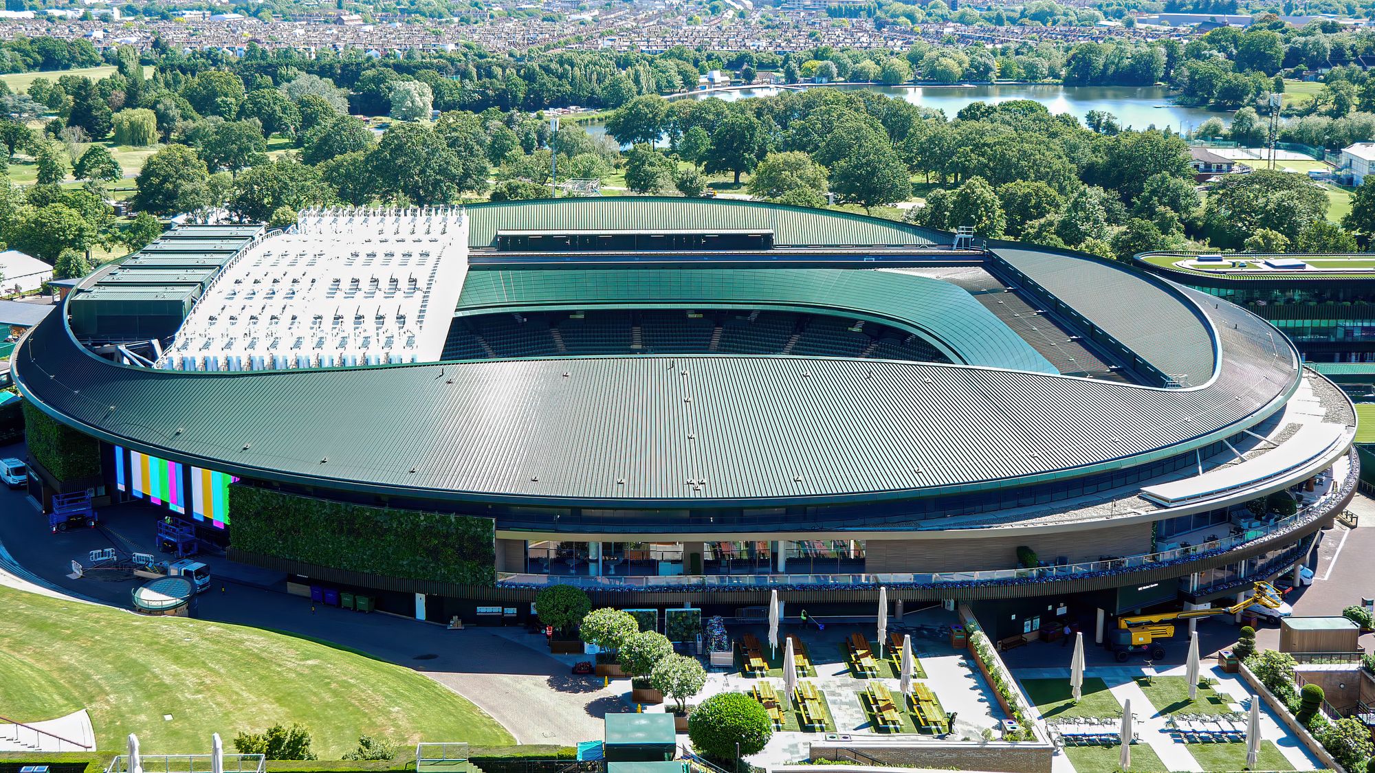 Arial shot of the iconic Wimbledon tennis stadium in the summer.