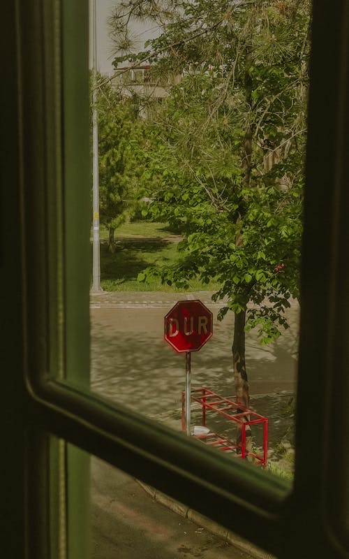 A stop sign is seen through a window