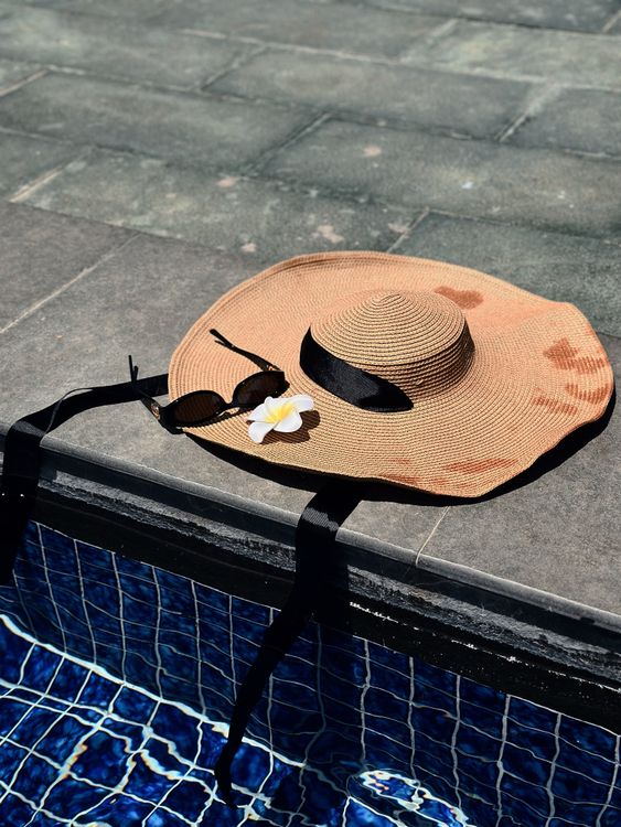 Flower and Sunglasses on Sunhat by Swimming Pool · Free Stock Photo