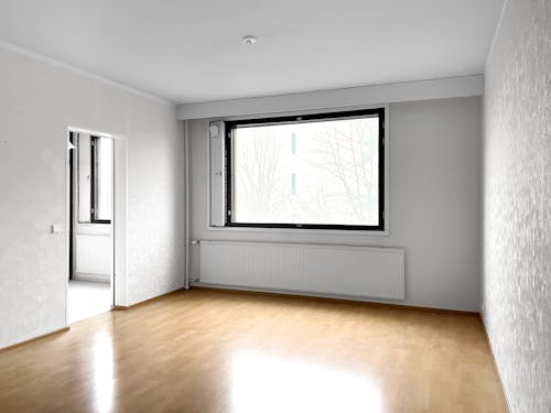 Empty room with hardwood floors and windows