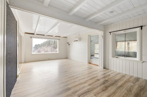 A room with hardwood floors and a white ceiling