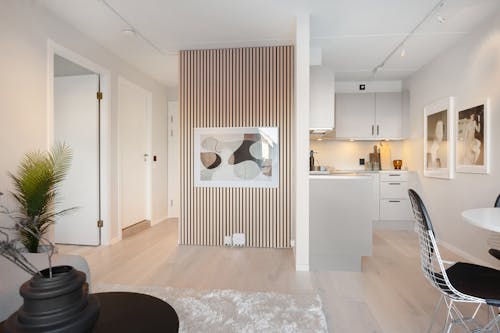 A white and black living room with a wooden floor