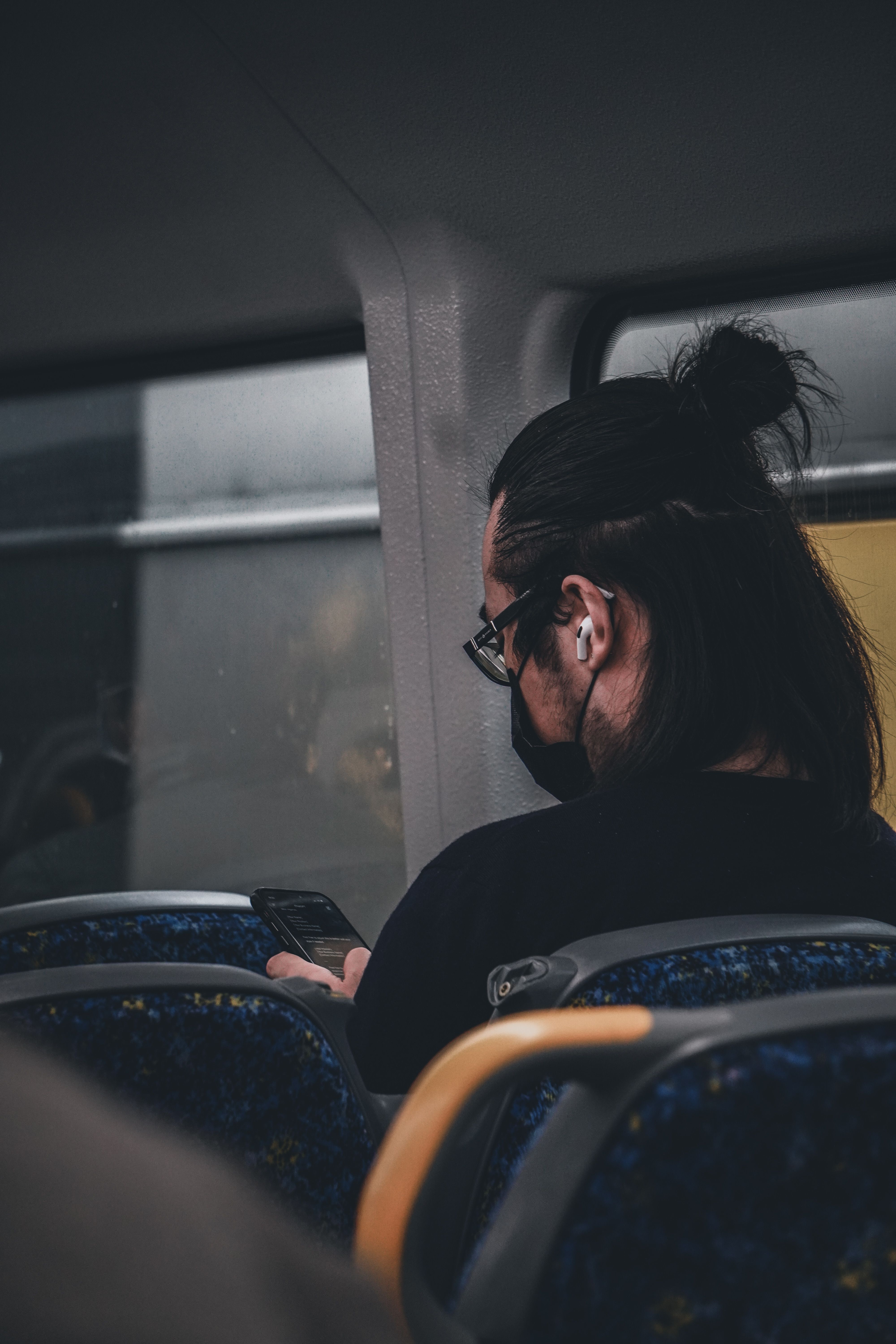person wearing wireless earbuds commute