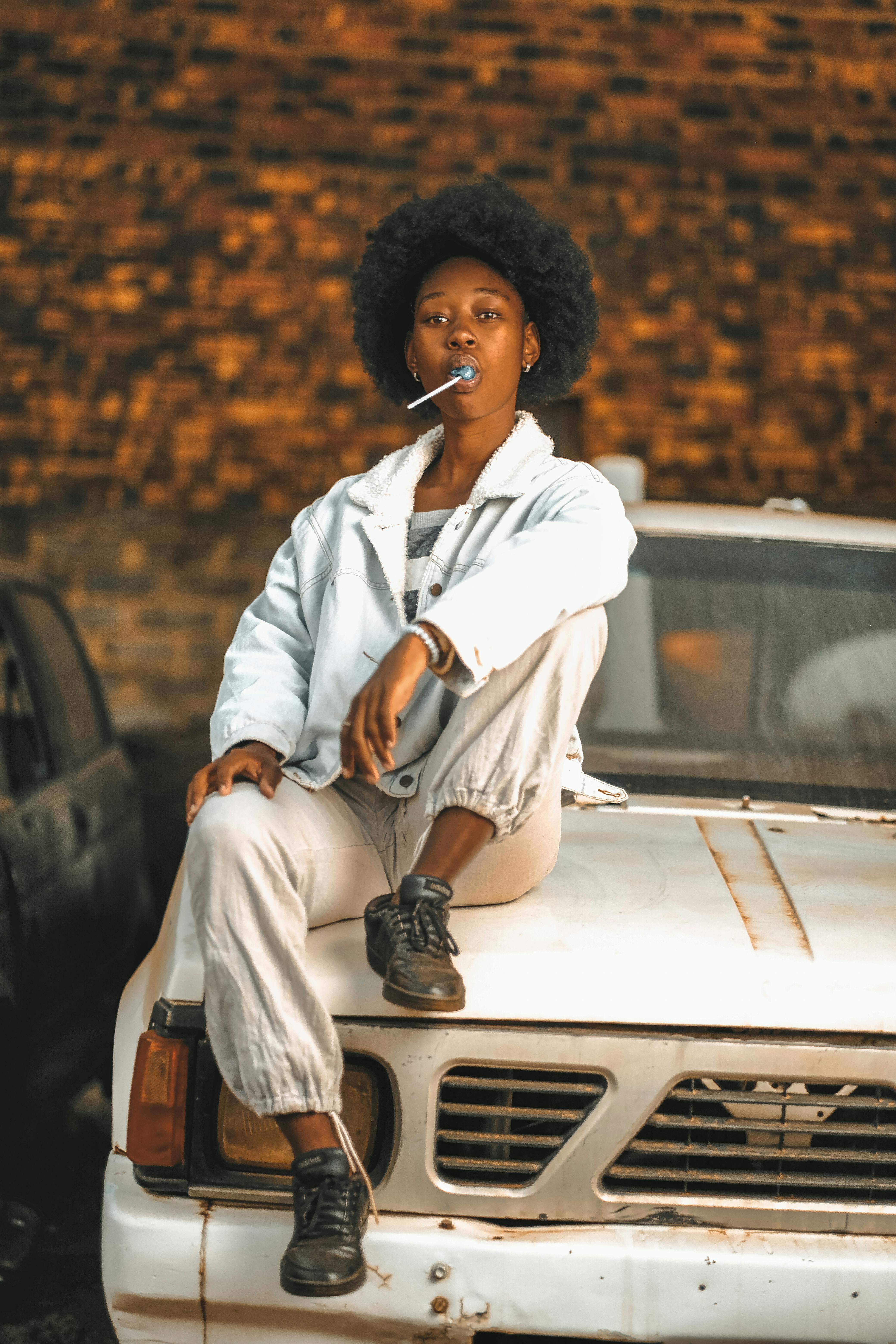 woman with lollipop on a vintage car