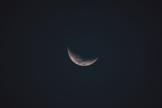 A detailed view of a crescent moon set against a dark night sky, ideal for astrology or astronomy content.