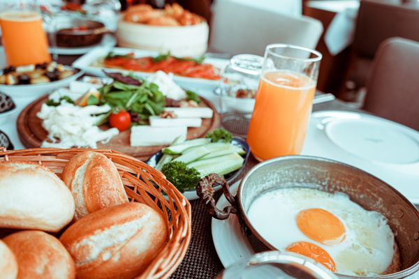 Breakfast table with orange juice and eggs