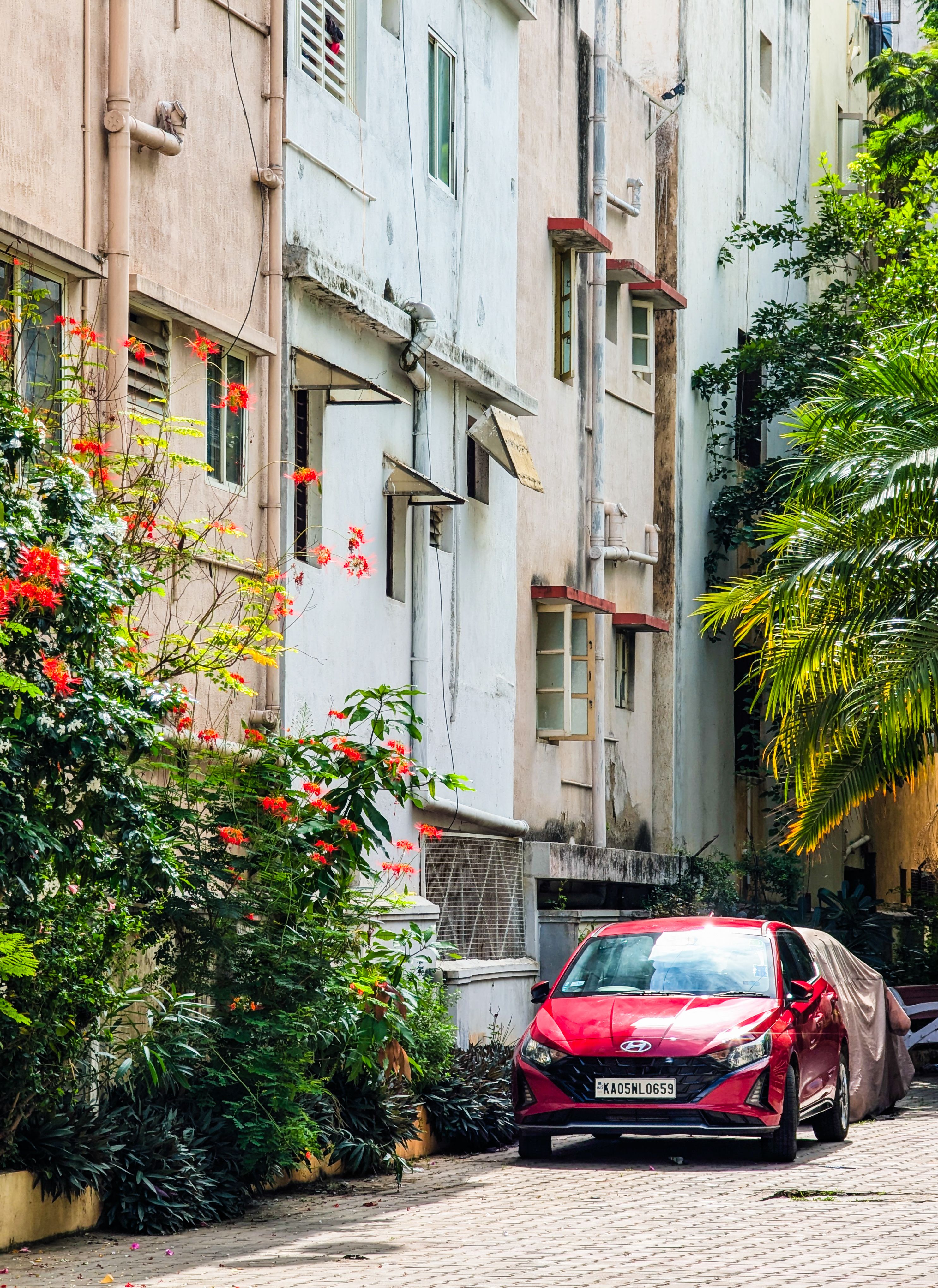 A red car parked in front of a building · Free Stock Photo