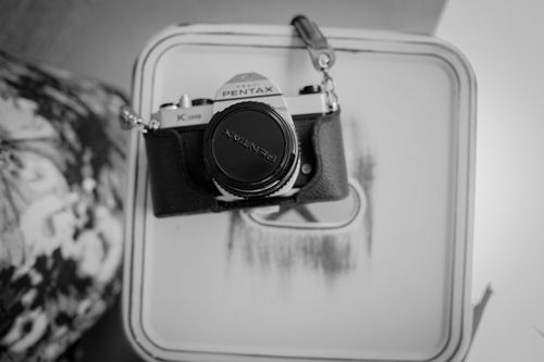 Free Classic Pentax camera displayed in a black and white artistic composition. Stock Photo