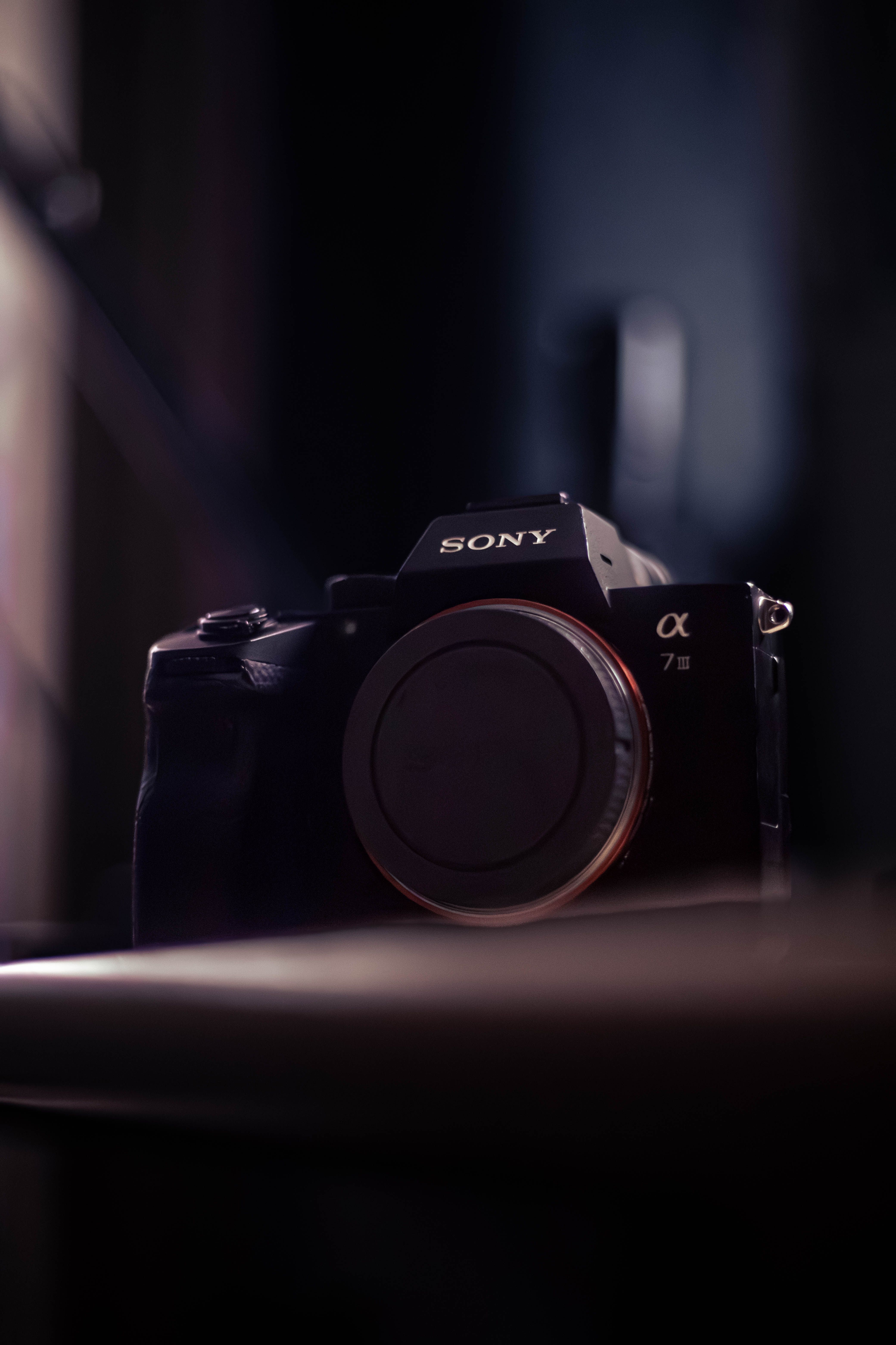 Close-up of a pro camera in moody light, highlighting materials and build that drive embodied carbon.