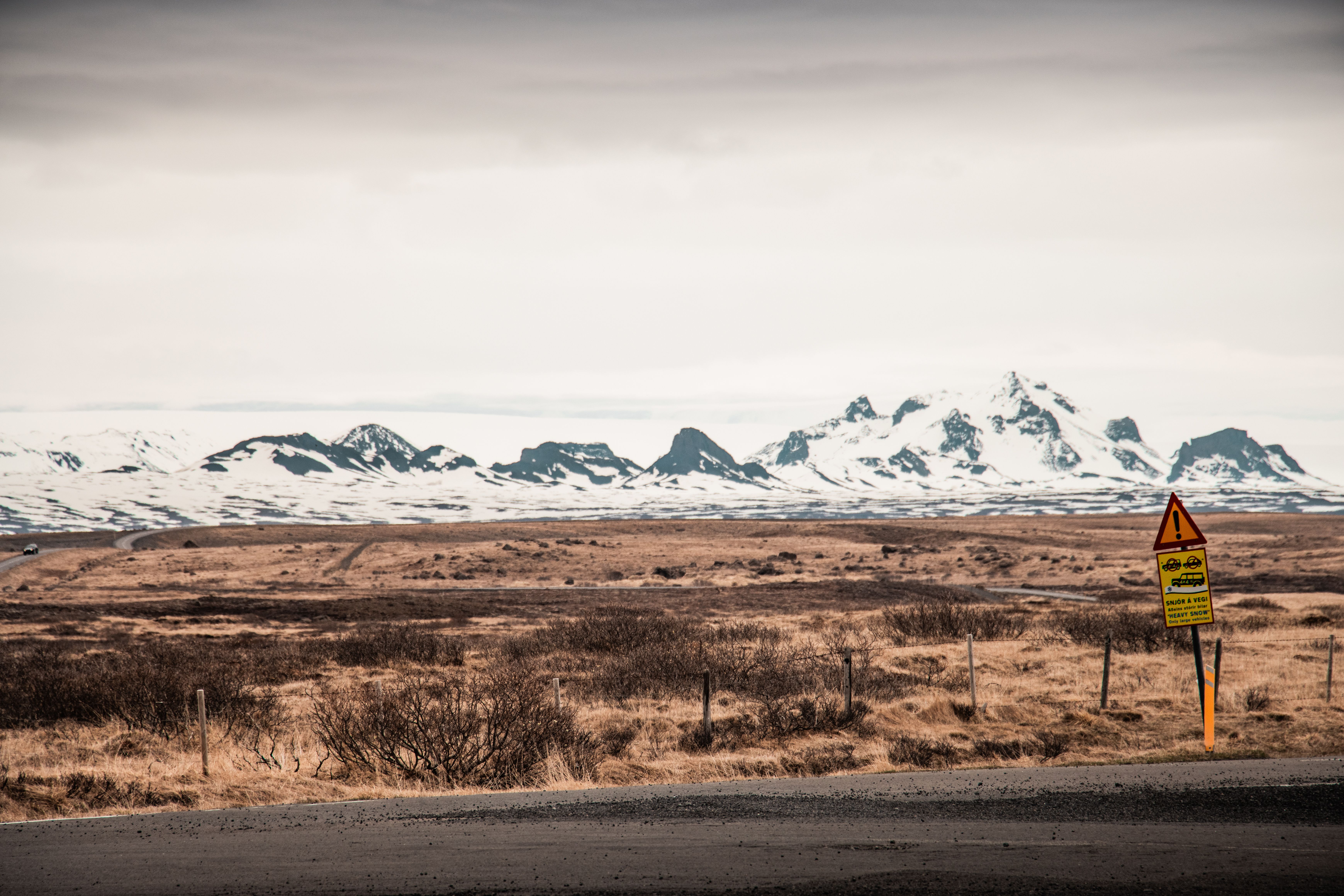 Snowy road in rural Iceland with mountains in the background