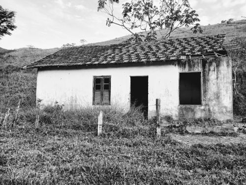 Free Rustic abandoned farmhouse surrounded by nature, showcasing decay and solitude. Stock Photo
