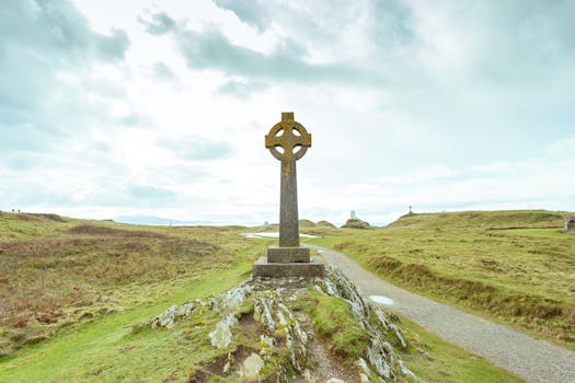 Rustic Celtic cross monument on Llanddwyn Island, showcasing Welsh cultural heritage.