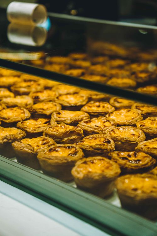 Free Close-up of freshly baked egg tarts displayed in a Kuala Lumpur bakery. Stock Photo