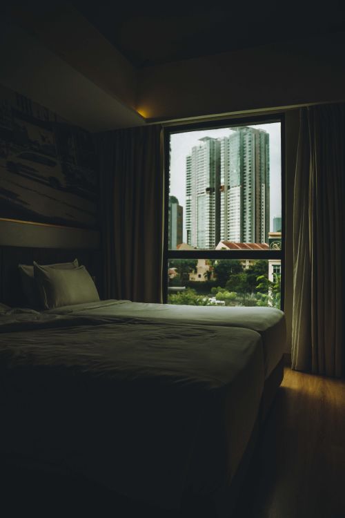 Free Elegant hotel room interior with a view of Kuala Lumpur skyline through the window. Stock Photo