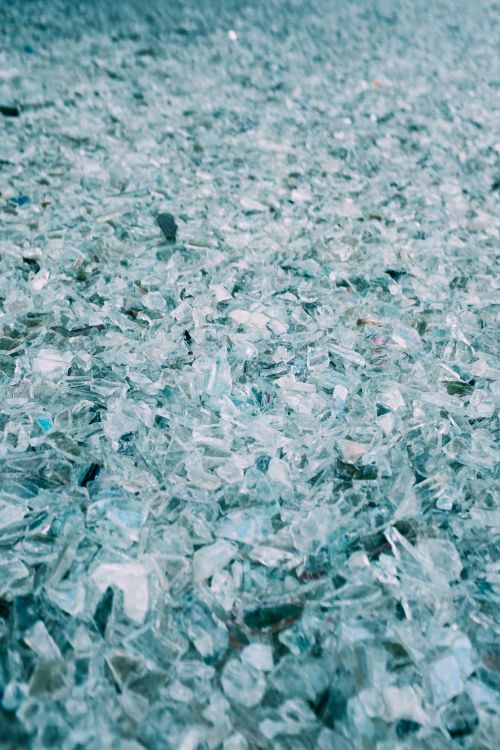 Free Detailed close-up of shattered glass pieces spread on a surface, creating an abstract pattern. Stock Photo