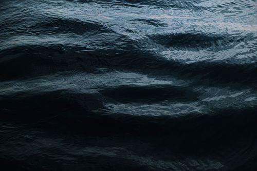 Free Close-up of dark ocean water with smooth ripples creating a textured surface. Stock Photo