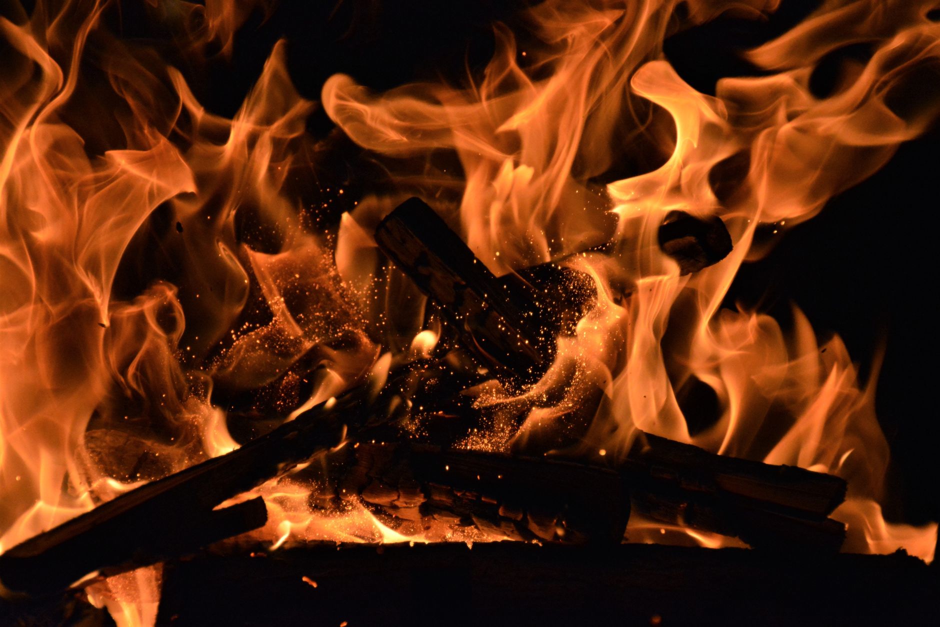 Close-up of roaring flames with glowing embers radiating heat and light. Perfect for warm and vivid backgrounds.