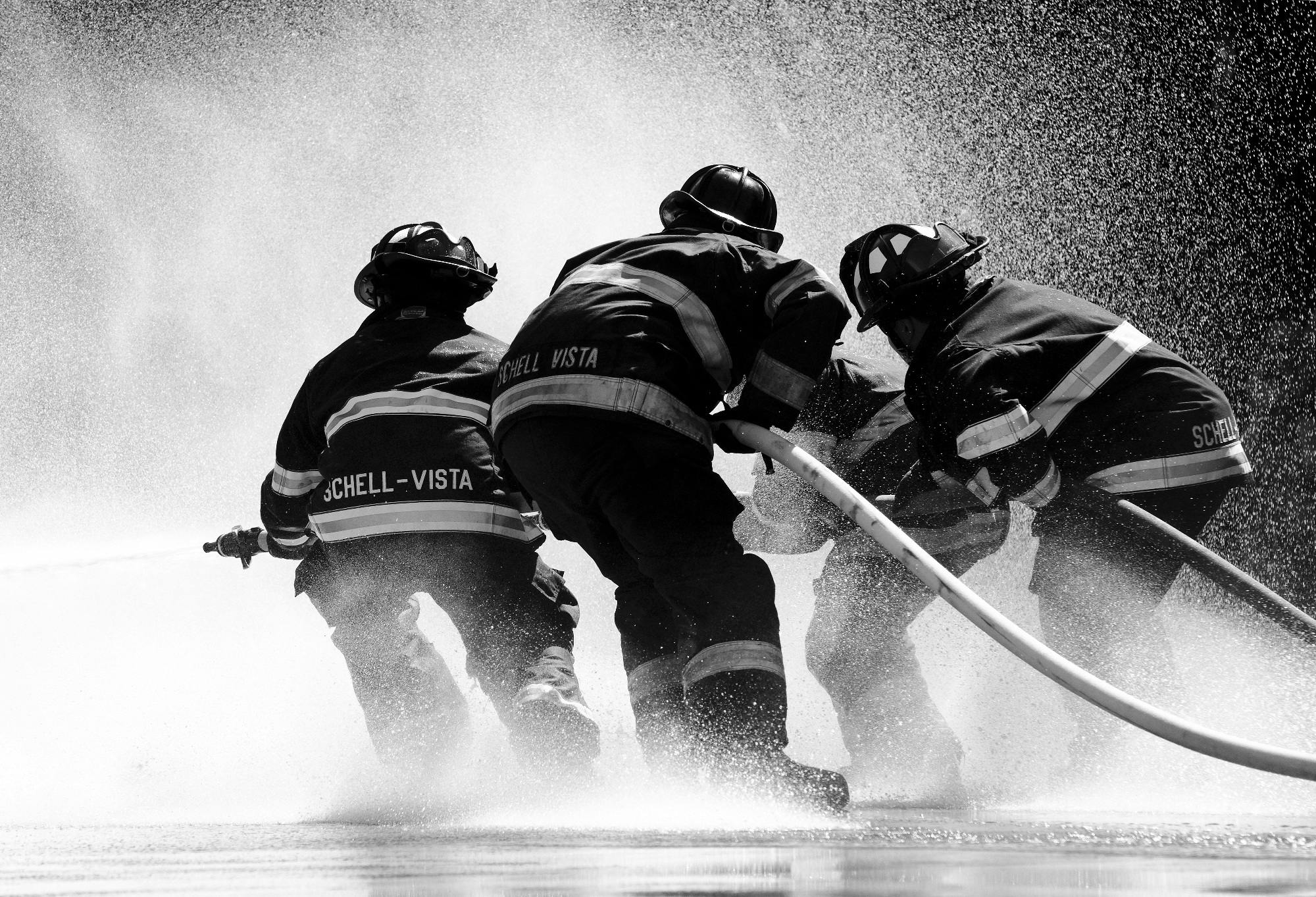 grayscale photo of firemen