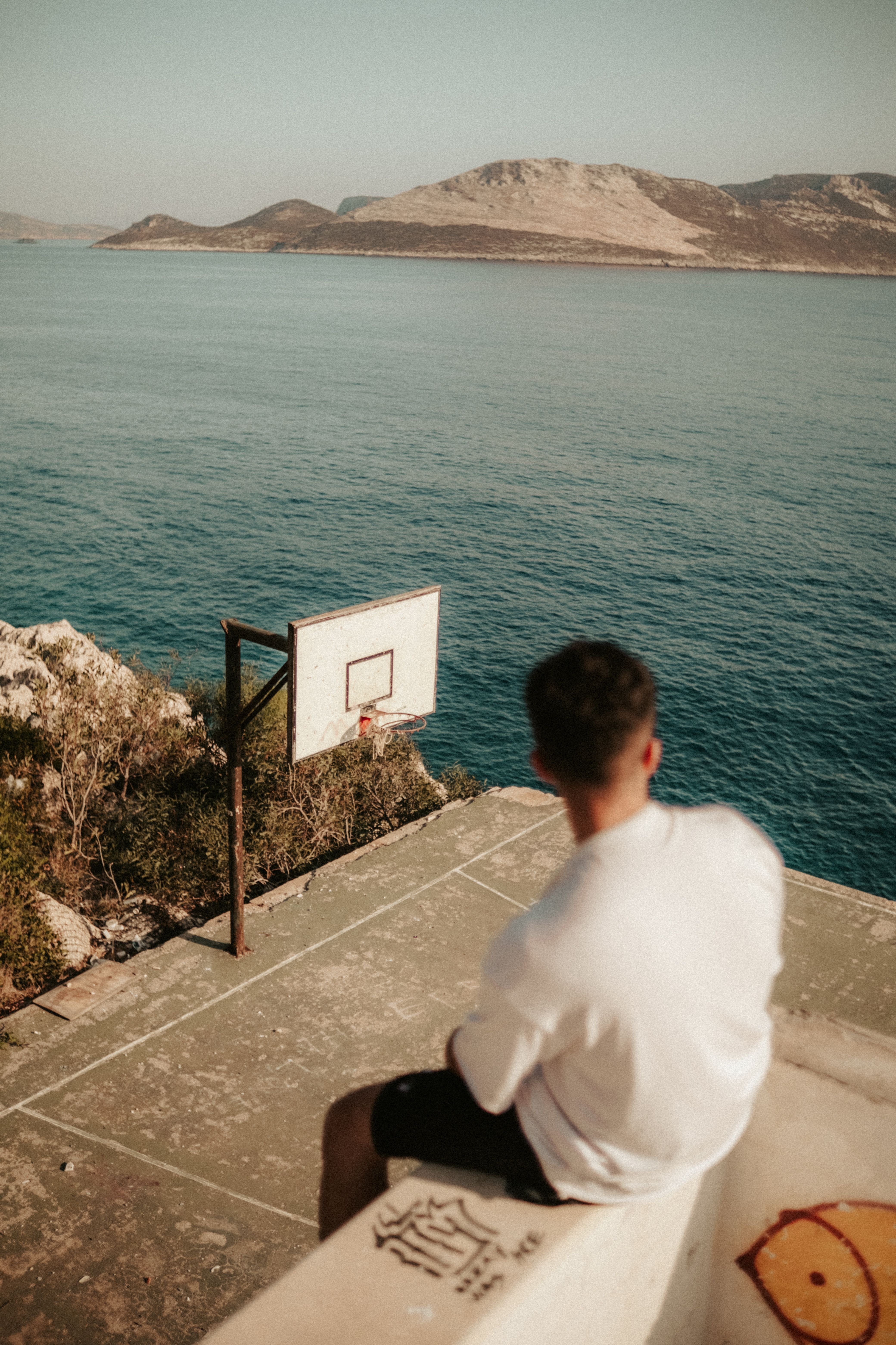 Man on Basketball Field by the Shore
