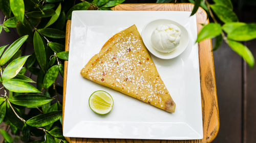 Free Crepe served with ice cream and a slice of lime on a square plate, viewed from above. Stock Photo