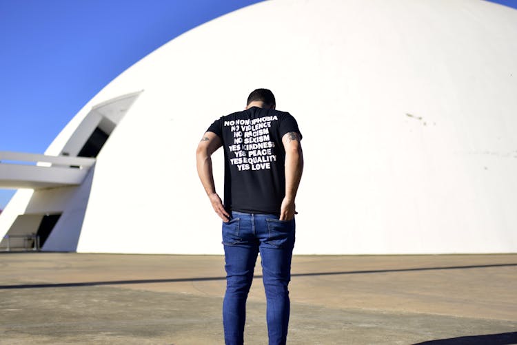 Man Standing In Front Of White Structure